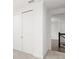 Hallway with neutral carpet, and a view to a stairway with dark railing at 8106 Mabury Ln, Orlando, FL 32832