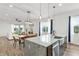 Open kitchen area features a granite island, breakfast bar, dining area and view into the living room at 8106 Mabury Ln, Orlando, FL 32832