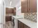 Laundry room with wood-look flooring, granite countertops, cabinetry, and new appliances at 8106 Mabury Ln, Orlando, FL 32832