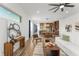 Open-concept living area with cohesive design, seamlessly connecting the living room, dining area and kitchen at 8106 Mabury Ln, Orlando, FL 32832