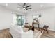Open concept living room with wood-look flooring, natural light, modern furniture, and stylish decor at 8106 Mabury Ln, Orlando, FL 32832