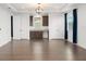 Stylish living room featuring hardwood floors, a modern light fixture, and a convenient wet bar at 8106 Mabury Ln, Orlando, FL 32832