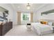 Bright main bedroom with plush carpeting, tray ceiling, large windows, and elegant furnishings at 8106 Mabury Ln, Orlando, FL 32832