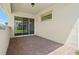 Large covered patio with brick pavers and sliding glass doors at 8106 Mabury Ln, Orlando, FL 32832