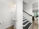 Powder room featuring a pedestal sink and hardwood floors that flow to a staircase at 8106 Mabury Ln, Orlando, FL 32832