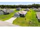 Overhead view of a house with blue siding, long driveway and a two-car garage at 9020 Se 42Nd Ct, Ocala, FL 34480