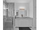 Bright bathroom featuring a double vanity, modern lighting, and a walk-in shower with glass door at 917 Dekleva Dr, Apopka, FL 32712