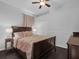 Comfortable bedroom with a dark wood bed frame, matching side tables, and a large window at 917 Dekleva Dr, Apopka, FL 32712