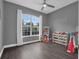 Bedroom with a large window offering natural light and a decorative name sign on the wall at 917 Dekleva Dr, Apopka, FL 32712