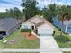 Inviting one-story home featuring a two-car garage, landscaped front yard, and a charming entrance at 917 Dekleva Dr, Apopka, FL 32712