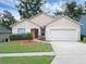 Charming one-story home with a well-maintained lawn, a two-car garage, and attractive landscaping at 917 Dekleva Dr, Apopka, FL 32712