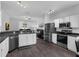Well-equipped kitchen featuring stainless steel appliances, dark countertops, and an open view of the living area at 917 Dekleva Dr, Apopka, FL 32712