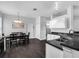 Open kitchen and dining area with stainless steel appliances, dark countertops, and ample cabinet space at 917 Dekleva Dr, Apopka, FL 32712