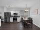 Eat-in kitchen with modern appliances, a wooden dining table, and dark flooring, creating a cozy atmosphere at 917 Dekleva Dr, Apopka, FL 32712