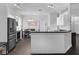 Modern kitchen with stainless steel appliances, a breakfast bar, and an adjacent dining area, perfect for gatherings at 917 Dekleva Dr, Apopka, FL 32712