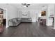Open-concept living room featuring dark wood floors, a large couch, and plenty of natural light at 917 Dekleva Dr, Apopka, FL 32712