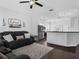 Open-concept living room featuring a cozy sofa and seamless connection to the modern kitchen space at 917 Dekleva Dr, Apopka, FL 32712