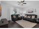 Bright living room with dark wood floors, ceiling fan, and comfortable seating with a large window at 917 Dekleva Dr, Apopka, FL 32712