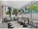 Enclosed patio featuring modern furniture, string lights, and a view of the fenced backyard at 917 Dekleva Dr, Apopka, FL 32712