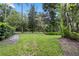 Well-maintained front yard featuring lush lawn, mature trees, and manicured hedges at 938 Southridge Trl, Altamonte Springs, FL 32714