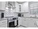 Bright kitchen features stainless steel appliances, white cabinets, and gray countertops at 938 Southridge Trl, Altamonte Springs, FL 32714