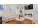 Cozy living room with hardwood floors, modern fireplace, and a comfortable white sofa at 938 Southridge Trl, Altamonte Springs, FL 32714