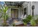 Cozy covered patio featuring comfortable seating and lush tropical plants at 938 Southridge Trl, Altamonte Springs, FL 32714