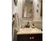 Bathroom featuring a vanity with framed mirror and decorative hand towels at 1022 Love Ln # 35, Apopka, FL 32703