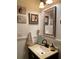 Charming powder room features wainscoting, decorative art, and a pedestal sink at 1022 Love Ln # 35, Apopka, FL 32703
