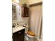 Bathroom featuring a vanity, toilet, tub, and a cabinet with an arrangement of flowers on top at 1022 Love Ln # 35, Apopka, FL 32703