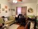 Living area with a sofa, desk, and a ceiling fan at 1022 Love Ln # 35, Apopka, FL 32703