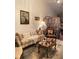 Cozy living room features decorative furnishings, painting of peacock and tiled flooring at 1022 Love Ln # 35, Apopka, FL 32703