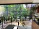 Charming screened patio featuring dining and sitting area surrounded by lush garden at 1022 Love Ln # 35, Apopka, FL 32703