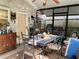 Inviting sunroom with rustic furniture and garden views, creating a serene indoor-outdoor space at 1022 Love Ln # 35, Apopka, FL 32703