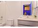 Bright bathroom featuring a sink, toilet, and shower, with a peek into the vibrant play area beyond at 10293 Ebb Tide Ln, Orlando, FL 32821