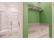 Bright bathroom featuring a glass-enclosed shower and closet space with built-in shelving at 10293 Ebb Tide Ln, Orlando, FL 32821