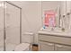 Bright bathroom vanity with light grey cabinets, a toilet, and a glass-enclosed shower at 10293 Ebb Tide Ln, Orlando, FL 32821