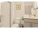 Bathroom featuring a glass-enclosed shower, white toilet, and vanity with ample counter space at 10293 Ebb Tide Ln, Orlando, FL 32821