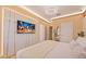 Bright bedroom features an entertainment center and modern chandelier at 10293 Ebb Tide Ln, Orlando, FL 32821