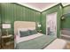Relaxing bedroom with green walls, accent lighting, and en-suite bathroom at 10293 Ebb Tide Ln, Orlando, FL 32821