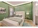 Relaxing bedroom with green walls, modern decor, and en-suite bathroom at 10293 Ebb Tide Ln, Orlando, FL 32821