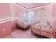 Pink princess themed bedroom featuring two carriage beds and a soft pink rug at 10293 Ebb Tide Ln, Orlando, FL 32821