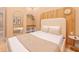 Bedroom with elegant decor, wood accent wall, large mirror, closet and accent table at 10293 Ebb Tide Ln, Orlando, FL 32821