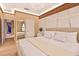 Bright bedroom features a decoratively paneled wall and modern chandelier at 10293 Ebb Tide Ln, Orlando, FL 32821