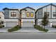 Modern townhomes featuring two-car garages, sleek design, and inviting curb appeal with manicured landscaping at 10293 Ebb Tide Ln, Orlando, FL 32821