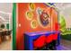 Game room featuring brick wall, Mario themed decor, countertop seating, and an open view to a dining area at 10293 Ebb Tide Ln, Orlando, FL 32821
