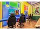 Bright game room with gaming chairs, TVs, and colorful cartoon themed decorations, perfect for entertainment at 10293 Ebb Tide Ln, Orlando, FL 32821