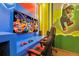 Colorful game room with gaming chairs, TV, and cartoon themed decorations, creating a fun atmosphere at 10293 Ebb Tide Ln, Orlando, FL 32821