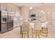 Modern kitchen featuring stone counter with bar seating, stainless steel appliances, and ample cabinet space at 10293 Ebb Tide Ln, Orlando, FL 32821