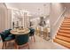 Open-concept kitchen with dining area featuring bar seating, modern lighting, and stainless steel appliances at 10293 Ebb Tide Ln, Orlando, FL 32821